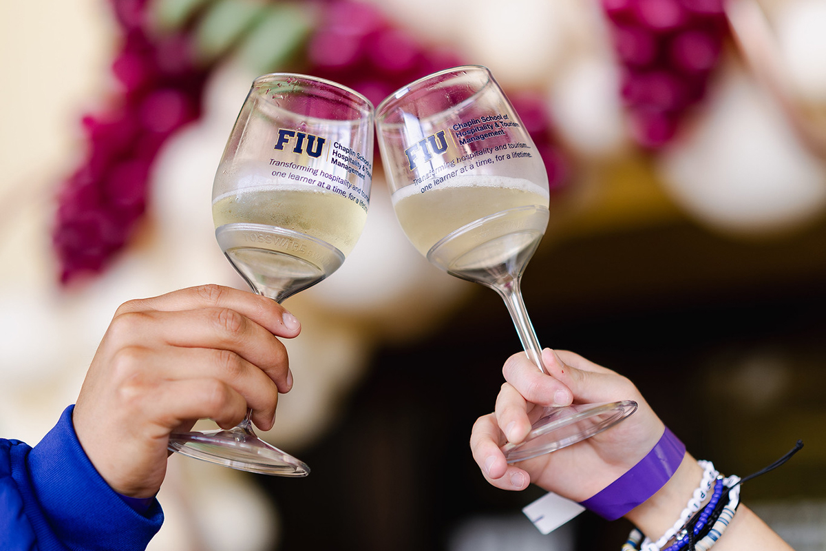 FIU wine glasses toasting